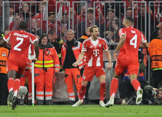 Bayern Munich's English forward #09 Harry Kane celebrates scoring the 2-2 goal with his teammates during the UEFA Champions League quarter-final second leg football match between FC Bayern Munich and Real Madrid in Munich, southern Germany, on April 15, 2026. (Photo by Alexandra BEIER / AFP)