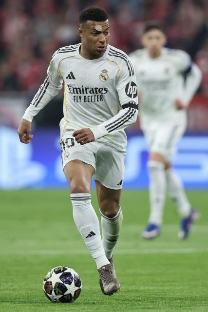 Real Madrid's French forward #10 Kylian Mbappe runs with the ball during the UEFA Champions League quarter-final second leg football match between FC Bayern Munich and Real Madrid in Munich, southern Germany, on April 15, 2026. (Photo by Alexandra BEIER / AFP)