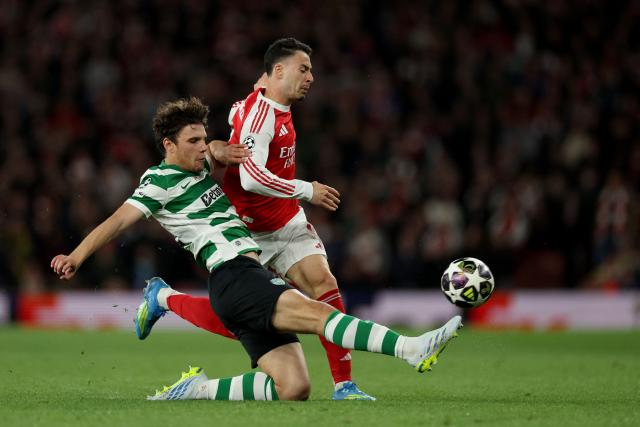 Sporting Lisbon's Portuguese defender #72 Eduardo Quaresma tackles Arsenal's Brazilian midfielder #11 Gabriel Martinelli during the UEFA Champions League quarter-final, second-leg football match between Arsenal and Sporting Lisbon at the Emirates Stadium in north London on April 15, 2026. (Photo by Adrian Dennis / AFP)