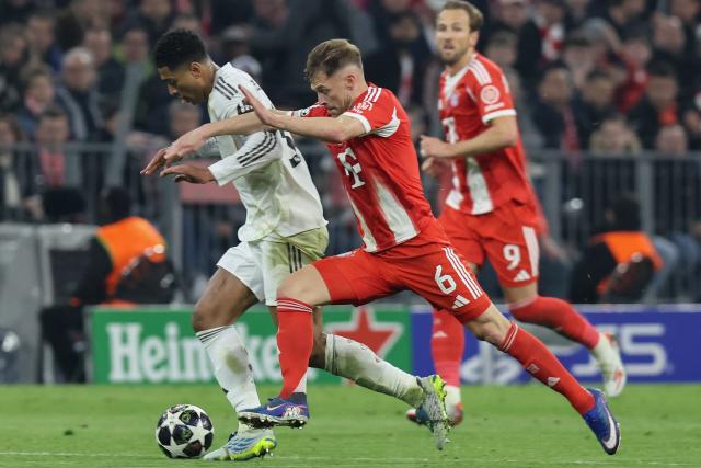 Bayern Munich's German midfielder #06 Joshua Kimmich (C) and Real Madrid's English midfielder #05 Jude Bellingham vie for the ball during the UEFA Champions League quarter-final second leg football match between FC Bayern Munich and Real Madrid in Munich, southern Germany, on April 15, 2026. (Photo by Alexandra BEIER / AFP)