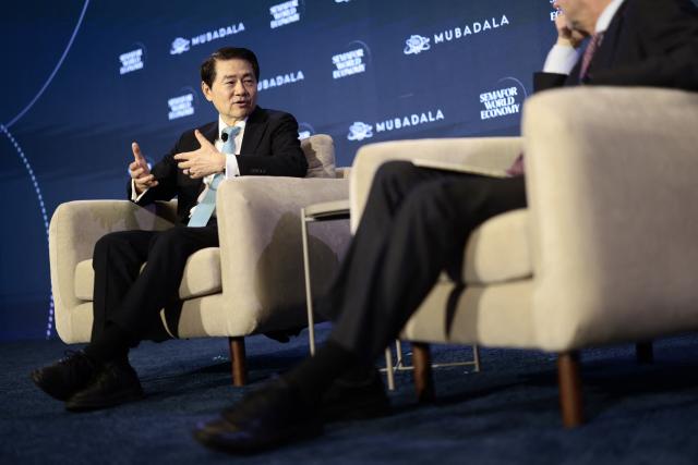 Dr. Huiyao Wang (L), Founder & President of Center for China and Globalization, speaks during the 2026 Semafor World Economy conference in Washington, DC, on April 15, 2026. (Photo by Kent NISHIMURA / AFP)