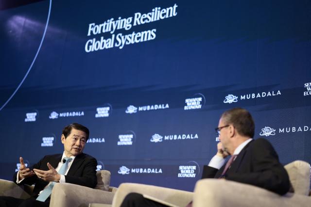 Dr. Huiyao Wang (L), Founder & President of Center for China and Globalization, speaks during the 2026 Semafor World Economy conference in Washington, DC, on April 15, 2026. (Photo by Kent NISHIMURA / AFP)