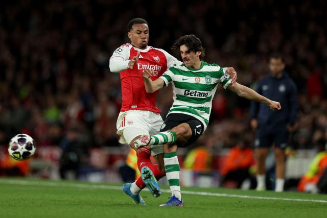 Arsenal's Brazilian defender #06 Gabriel Magalhaes battles for the ball with Sporting Lisbon's Portuguese striker #17 Francisco Trincao during the UEFA Champions League quarter-final, second-leg football match between Arsenal and Sporting Lisbon at the Emirates Stadium in north London on April 15, 2026. (Photo by Adrian Dennis / AFP)