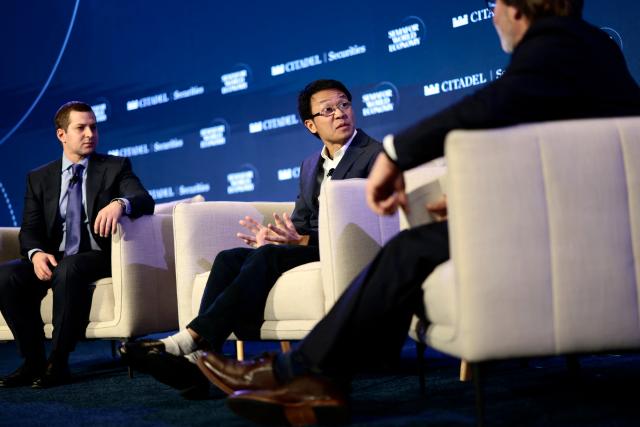 Scott Wu (C), CEO of Cognition, speaks as Brandon Reeves (L), Partner of Lux Capital, looks on during the 2026 Semafor World Economy conference in Washington, DC, on April 15, 2026. (Photo by Kent NISHIMURA / AFP)