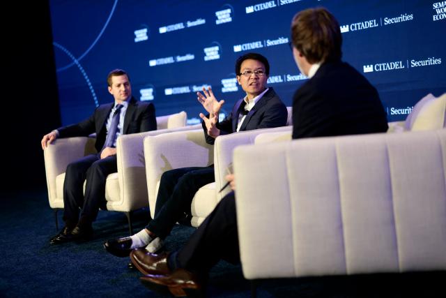 Scott Wu (C), CEO of Cognition, speaks as Brandon Reeves (L), Partner of Lux Capital, looks on during the 2026 Semafor World Economy conference in Washington, DC, on April 15, 2026. (Photo by Kent NISHIMURA / AFP)