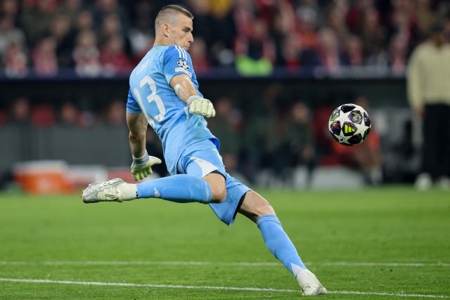 Real Madrid's Ukrainian goalkeeper #13 Andriy Lunin kicks out the ball during the UEFA Champions League quarter-final second leg football match between FC Bayern Munich and Real Madrid in Munich, southern Germany, on April 15, 2026. (Photo by Alexandra BEIER / AFP)