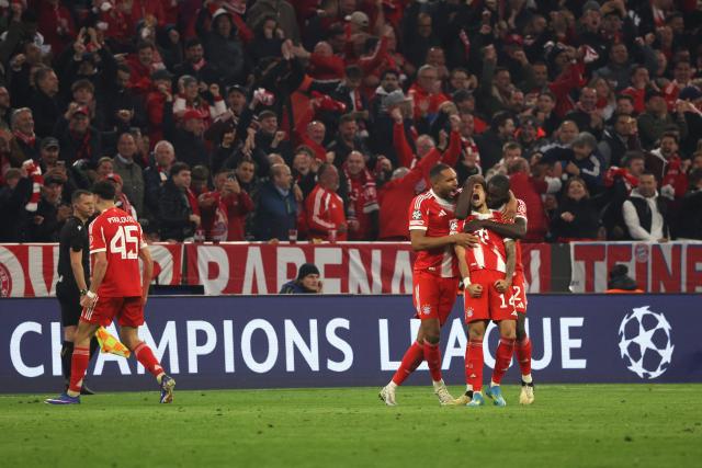 Bayern Munich's Colombian forward #14 Luis Diaz is celebrated by team mates after scoring the equalizing 3-3 goal during the UEFA Champions League quarter-final second leg football match between FC Bayern Munich and Real Madrid in Munich, southern Germany, on April 15, 2026. (Photo by Karl-Josef HILDENBRAND / AFP)