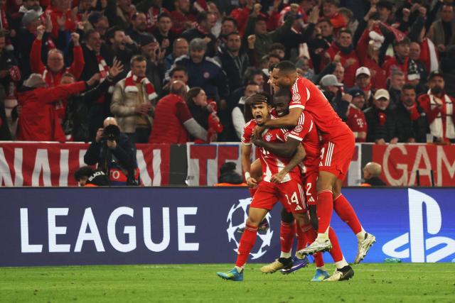 Bayern Munich's Colombian forward #14 Luis Diaz (L) celebrates with Bayern Munich's French defender #02 Dayot Upamecano (C) and Bayern Munich's German defender #04 Jonathan Tah (R) after scoring the equalizing 3-3 goal during the UEFA Champions League quarter-final second leg football match between FC Bayern Munich and Real Madrid in Munich, southern Germany, on April 15, 2026. (Photo by Karl-Josef HILDENBRAND / AFP)