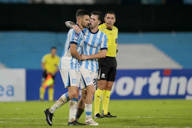 Racing's forward #09 Adrian Martinez (L) celebrates scoring his team's second goal with teammate midfielder #20 Baltasar Rodriguez (R) during the Copa Sudamericana group stage football match between Argentina's Racing Club and Brazil's Botafogo at the Presidente Peron 'El Cilindro' stadium, in Avellaneda, Buenos Aires province, Argentina on April 15, 2026. (Photo by JUAN MABROMATA / AFP)