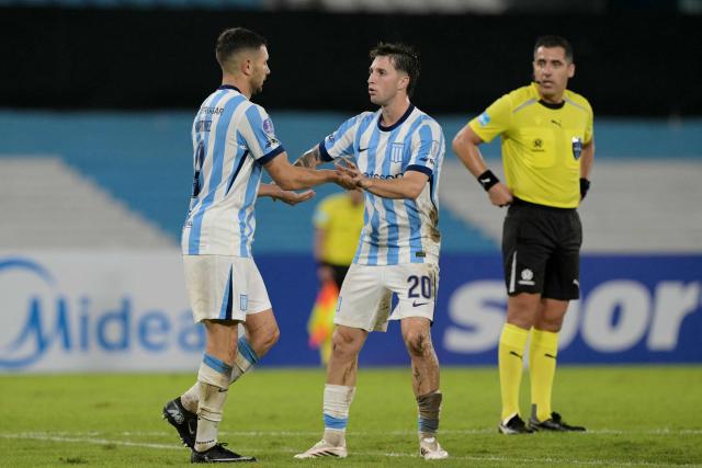 Racing's forward #09 Adrian Martinez (L) celebrates scoring his team's second goal with teammate midfielder #20 Baltasar Rodriguez (R) during the Copa Sudamericana group stage football match between Argentina's Racing Club and Brazil's Botafogo at the Presidente Peron 'El Cilindro' stadium, in Avellaneda, Buenos Aires province, Argentina on April 15, 2026. (Photo by JUAN MABROMATA / AFP)