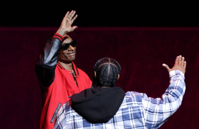 US rapper and founder/producer of Death Row Pictures, Snoop Dogg (L) and US actor Jonathan Daviss greet each other on stage during Universal Pictures and Focus Features presentation at CinemaCon at The Colosseum at Caesars Palace in Las Vegas, Nevada, on April 15, 2026. (Photo by VALERIE MACON / AFP)