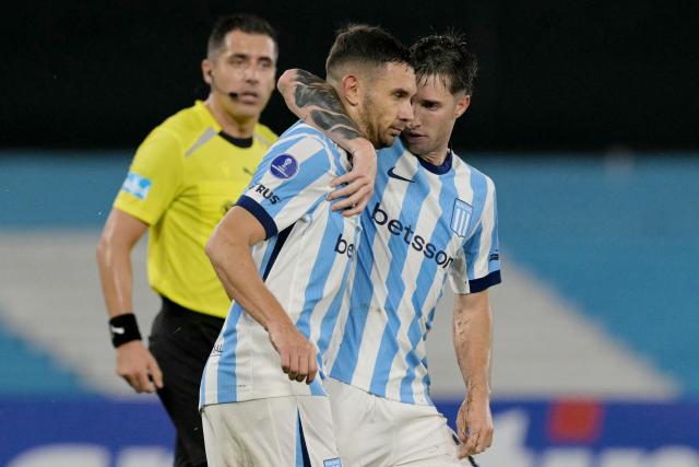 Racing's forward #09 Adrian Martinez (L) celebrates scoring his team's second goal with teammate midfielder #20 Baltasar Rodriguez (R) during the Copa Sudamericana group stage football match between Argentina's Racing Club and Brazil's Botafogo at the Presidente Peron 'El Cilindro' stadium, in Avellaneda, Buenos Aires province, Argentina on April 15, 2026. (Photo by JUAN MABROMATA / AFP)