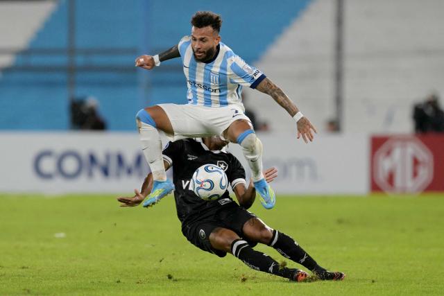 Racing's Colombian forward #07 Duvan Vergara (in front) and Botafogo's midfielder #08 Danilo (behind) fight for the ball during the Copa Sudamericana group stage football match between Argentina's Racing Club and Brazil's Botafogo at the Presidente Peron 'El Cilindro' stadium, in Avellaneda, Buenos Aires province, Argentina on April 15, 2026. (Photo by JUAN MABROMATA / AFP)