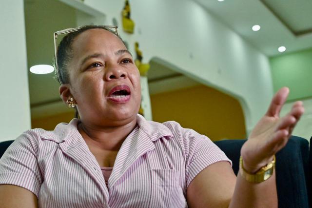 Katty Hurtado, mother of Ecuadorian mixed martial arts fighter Michael Morales, speaks during an interview with AFP in Pasaje, El Oro province, Ecuador on April 4, 2026. In a tropical town in Ecuador, children no longer dream only of becoming football players to escape poverty. They also want to be UFC fighters like Michael "Spiderman" Morales, a beast in the octagon who has become a local idol. The 26-year-old fighter has been immortalized in murals and is now the hero of the children on the streets of Pasaje, a town ravaged by violence. (Photo by Marcos PIN / AFP)