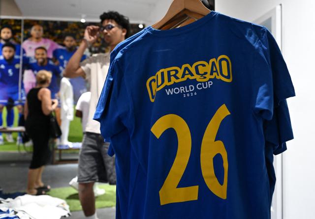View of a jersey at the Curacao national football team official fan store in Willemstad, Curacao, in the Dutch Caribbean, on April 8, 2026. Small island, big dreams. The poster of Curacao’s national football team hangs at the entrance of Marchena, a working-class neighborhood of Willemstad, the capital of the smallest territory ever to qualify for a World Cup. (Photo by Raul ARBOLEDA / AFP)