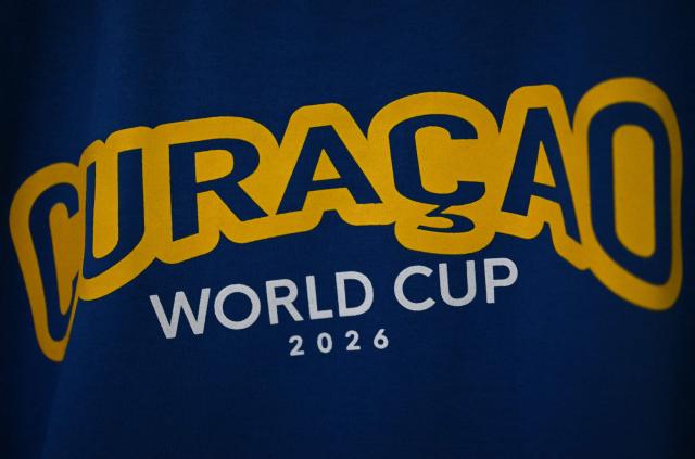 View of a sign at the official fan store of the Curacao national football team in Willemstad, Curacao, in the Dutch Caribbean, on April 8, 2026. Small island, big dreams. The poster of Curacao’s national football team hangs at the entrance of Marchena, a working-class neighborhood of Willemstad, the capital of the smallest territory ever to qualify for a World Cup. (Photo by Raul ARBOLEDA / AFP)