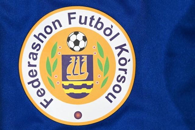 View of the Curacao Football Federation logo at an official fan store in Willemstad, Curacao, in the Dutch Caribbean, on April 8, 2026. Small island, big dreams. The poster of Curacao’s national football team hangs at the entrance of Marchena, a working-class neighborhood of Willemstad, the capital of the smallest territory ever to qualify for a World Cup. (Photo by Raul ARBOLEDA / AFP)