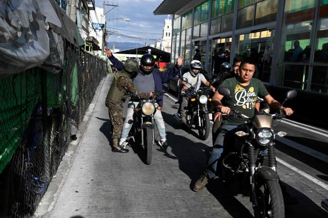 Guatemala's soldiers search motorcyclists at traffic lights stops in streets in Guatemala City on April 15, 2026. Military forces put in place the 'Sentinel Plan' which seeks to provide security in the metropolitan area to curb extortion and neutralize gang operations. (Photo by JOHAN ORDONEZ / AFP)