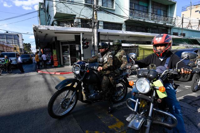 Guatemala's soldiers patrol the streets of Guatemala City on April 15, 2026. Military forces put in place the 'Sentinel Plan' which seeks to provide security in the metropolitan area to curb extortion and neutralize gang operations. (Photo by JOHAN ORDONEZ / AFP)