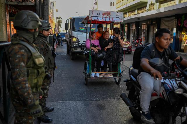 Guatemala's soldiers stand guard on a street of Guatemala City on April 15, 2026. Military forces put in place the 'Sentinel Plan' which seeks to provide security in the metropolitan area to curb extortion and neutralize gang operations. (Photo by JOHAN ORDONEZ / AFP)