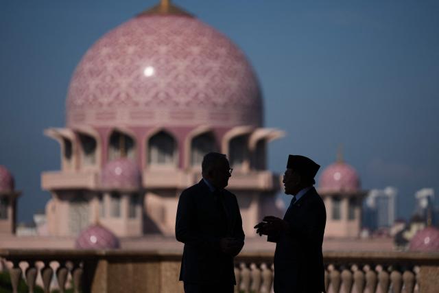 Australia's Prime Minister Anthony Albanese (L) talks with Malaysia's Prime Minister Anwar Ibrahim after an official welcoming ceremony at the Federal Government office "Putra Perdana" in Putrajaya on April 16, 2026. (Photo by Vincent Thian / POOL / AFP)