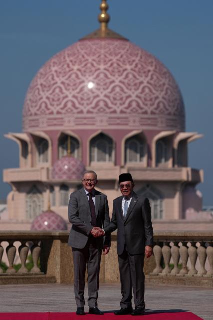 Australia's Prime Minister Anthony Albanese (L) shakes hands with Malaysia's Prime Minister Anwar Ibrahim after an official welcoming ceremony at the Federal Government office "Putra Perdana" in Putrajaya on April 16, 2026. (Photo by Vincent Thian / POOL / AFP)