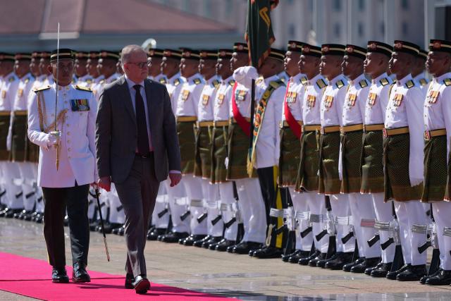 Australia's Prime Minister Anthony Albanese (2nd L) inspects an honour guard during an official welcoming ceremony at the Federal Government office "Putra Perdana" before a bilateral meeting with Malaysia's Prime Minister Anwar Ibrahim in Putrajaya on April 16, 2026. (Photo by Vincent Thian / POOL / AFP)