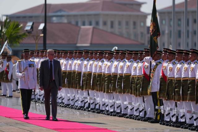 Australia's Prime Minister Anthony Albanese (2nd L) inspects an honour guard during an official welcoming ceremony at the Federal Government office "Putra Perdana" before a bilateral meeting with Malaysia's Prime Minister Anwar Ibrahim in Putrajaya on April 16, 2026. (Photo by Vincent Thian / POOL / AFP)