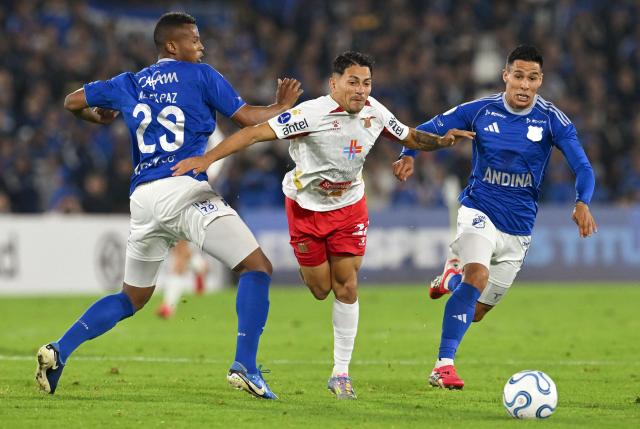 Boston River's midfielder #21 Franco Perez (C), Millonarios' defender # 29 Alex Moreno and midfielder #19 Mateo Garcia fight for the ball during the Copa Sudamericana group stage football match between Colombia's Millonarios and Uruguay's Boston River at the Nemesio Camacho El Campin Stadium in Bogota on April 15, 2026. (Photo by Raul ARBOLEDA / AFP)