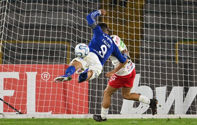 Millonarios' forward #09 Radamel Falcao and Boston River's defender #25 Agustin Aguirre fight for the ball during the Copa Sudamericana group stage football match between Colombia's Millonarios and Uruguay's Boston River at the Nemesio Camacho El Campin Stadium in Bogota on April 15, 2026. (Photo by Raul ARBOLEDA / AFP)