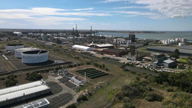 This photo shows an aerial view of the Viva Oil Refinery in Geelong on April 16, 2026 following an overnight fire with authorities warning of disruptions to domestic fuel supply. Towering columns of fire have engulfed a crucial Australian oil refinery after a chain of explosions, authorities said on April 16 as they warned of disruptions to domestic fuel supply. (Photo by William WEST / AFP)