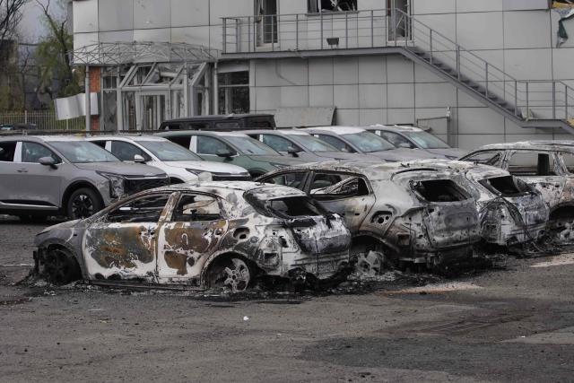 Burned-out cars are seen following a Russian strike in Kyiv on April 16, 2026, amid the Russian invasion of Ukraine. Russian strikes killed at least 12 people in Ukraine, local authorities said on April 16, after Moscow pummelled its neighbour in overnight attacks. (Photo by Serhii Okunev / AFP)