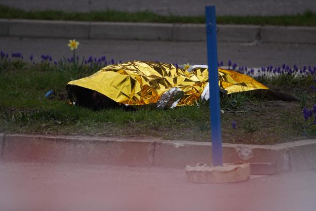 The body of a civilian lies on the ground following a Russian strike in Kyiv on April 16, 2026, amid the Russian invasion of Ukraine. Russian strikes killed at least 12 people in Ukraine, local authorities said on April 16, after Moscow pummelled its neighbour in overnight attacks. (Photo by Serhii Okunev / AFP)