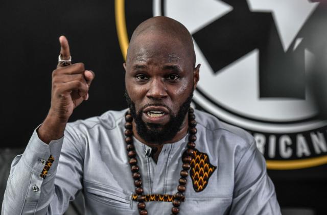 (FILES) French anti-colonial activist Kemi Seba  addresses a press conference on June 26, 2020 in Paris. Police in South Africa said Thursday they had arrested anti-Western activist Kemi Seba wanted in Benin for "inciting rebellion" after he supported a foiled coup in December.
Preparations were being made for Seba's extradition after his arrest with his son on April 13, 2026 the police said in a statement. 
Seba, whose real name is Stellio Gilles Robert Capo Chichi, heads the NGO Pan-Africanist Emergency and is known for his radical tirades against France and African governments allied with Paris. (Photo by STEPHANE DE SAKUTIN / AFP)