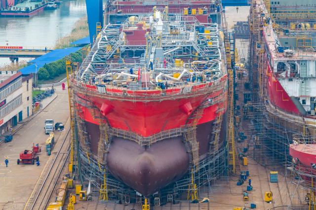 Workers build large vessels at the Jinling Shipyard, operated by China Merchants Industry in Nanjing, in China's eastern Jiangsu province, on April 16, 2026. (Photo by CN-STR / AFP) / China OUT