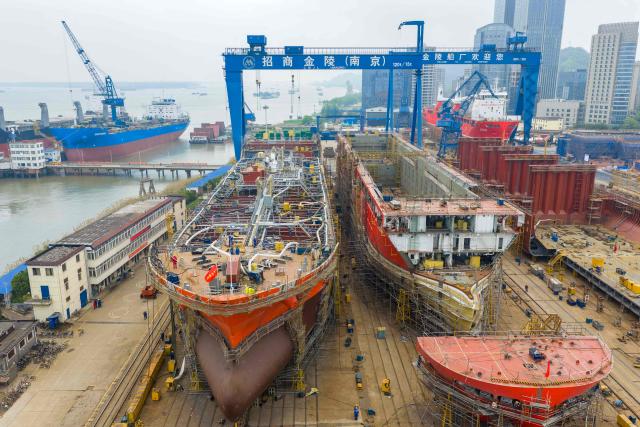 Workers build large vessels at the Jinling Shipyard, operated by China Merchants Industry in Nanjing, in China's eastern Jiangsu province, on April 16, 2026. (Photo by CN-STR / AFP) / China OUT