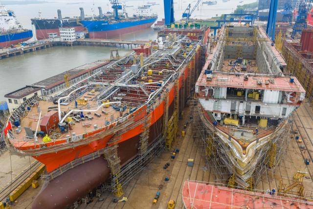 Workers build large vessels at the Jinling Shipyard, operated by China Merchants Industry in Nanjing, in China's eastern Jiangsu province, on April 16, 2026. (Photo by CN-STR / AFP) / China OUT