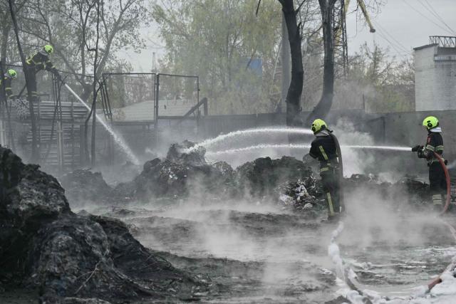 Firefighters work at a site following a Russian strike in Kyiv on April 16, 2026, amid the Russian invasion of Ukraine. Russian strikes killed at least 12 people in Ukraine, local authorities said on April 16, after Moscow pummelled its neighbour in overnight attacks. (Photo by Genya SAVILOV / AFP)