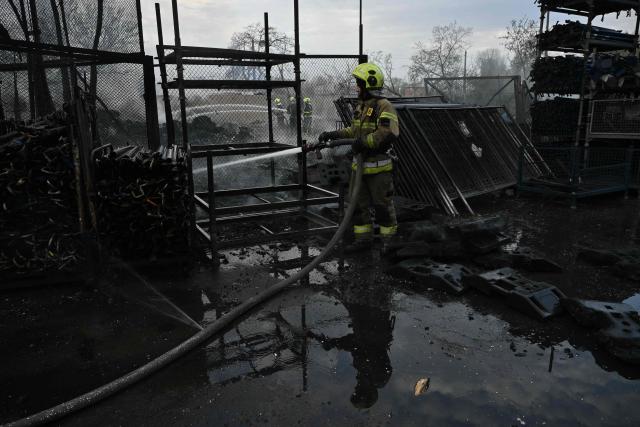 Firefighters work at a site following a Russian strike in Kyiv on April 16, 2026, amid the Russian invasion of Ukraine. Russian strikes killed at least 12 people in Ukraine, local authorities said on April 16, after Moscow pummelled its neighbour in overnight attacks. (Photo by Genya SAVILOV / AFP)