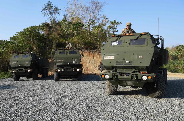 US soldiers operate High Mobility Artillery Rocket System (HIMARS) launchers prior to a live fire exercise during a joint exercise between the Philippines and the US at Fort Magsaysay, in the Philippines' Nueva Ecija province north of Manila on April 16, 2026. (Photo by Ted ALJIBE / AFP)