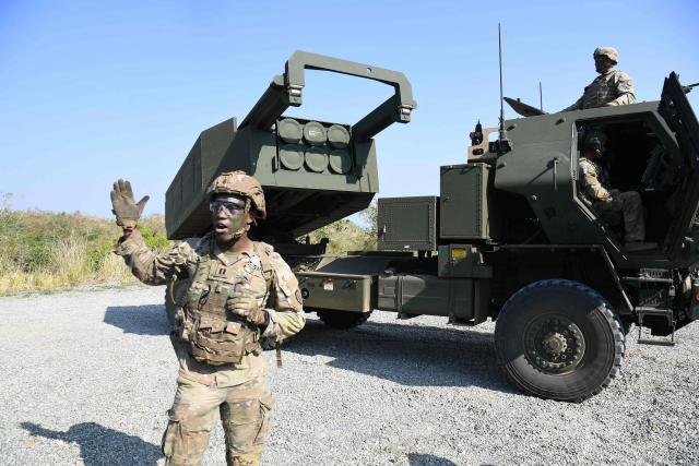 A US soldier gestures next to one of their High Mobility Artillery Rocket System (HIMARS)launchers during a joint exercise between the Philippines and the US at Fort Magsaysay, in the Philippines' Nueva Ecija province north of Manila on April 16, 2026. (Photo by Ted ALJIBE / AFP)