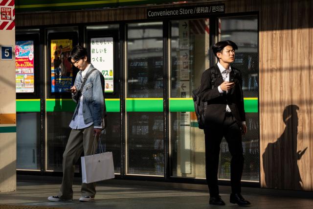 People wait for a train at Tokyo Station in Tokyo on April 16, 2026. (Photo by Yuichi YAMAZAKI / AFP)
