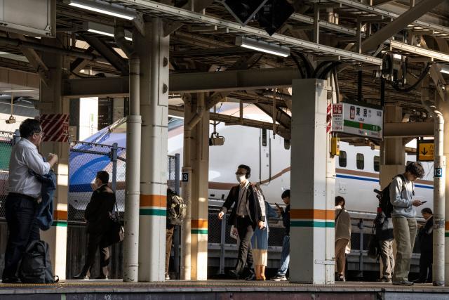 People wait for a train at Tokyo Station in Tokyo on April 16, 2026. (Photo by Yuichi YAMAZAKI / AFP)