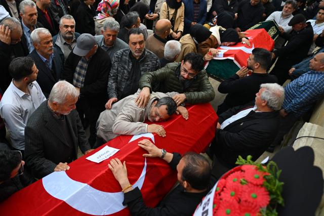 TOPSHOT - Family members and mourners attend the funerals for nine victims killed in a school shooting by a 14-year-old, an attack that has sent shockwaves across the country, with authorities saying the suspect had referenced a US mass killer in a WhatsApp profile image, in the southern province of Kahramanmaras on April 16, 2026. The funerals take place for eight children aged 10 and 11 and a 55-year-old teacher. (Photo by YASIN AKGUL / AFP)