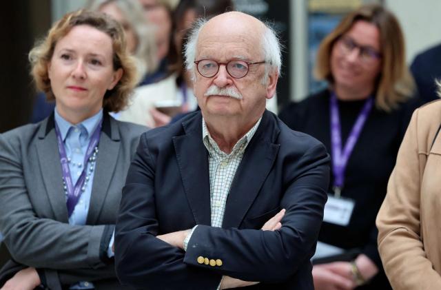 French writer Erik Orsenna listens during a visit to the International City of French Language (Cite Internationale de la Langue Francaise) to promote 'disconnecting' and 'reading' as alternatives to screens as part of his fight to ban social networks for the youngest in the castle of Villers-Cotterets, northern France on April 16, 2026. In response to the explosion in screen time among 6- to 17-year-olds and the impact of algorithms on our children, Emmanuel Macron has pledged to ban social media for those under 15. (Photo by Ludovic MARIN / POOL / AFP)