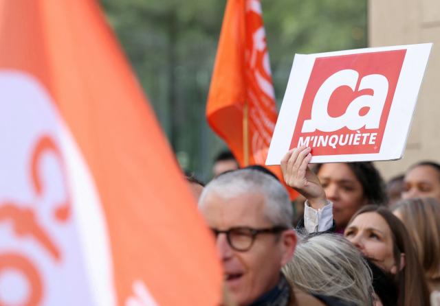 Employees of the leading magazine publisher in France Prisma Group gather during a demonstration against the Employment Protection Plan (PSE) in front of a building of the Prisma Media Group in Paris on April 16, 2026. Prisma Group announced to staff representatives on March 30, 2026 a plan to cut 261 jobs, representing 40% of its workforce, according to the CGT union. (Photo by ALAIN JOCARD / AFP)