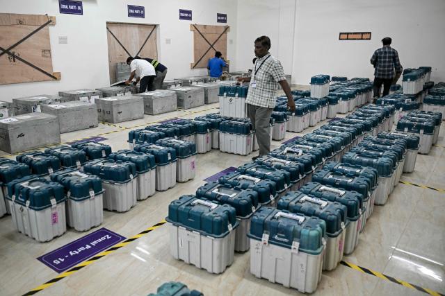 Poll officials arrange the Electronic Voting Machines (EVMs) in a strong room in Chennai on April 16, 2026 ahead of the Tamil Nadu Legislative Assembly election. (Photo by R. Satish BABU / AFP)