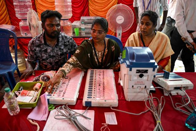 Poll officials prepare and install candidate names and symbols in Electronic Voting Machines (EVMs) in Chennai on April 16, 2026 ahead of the Tamil Nadu Legislative Assembly election. (Photo by R. Satish BABU / AFP)