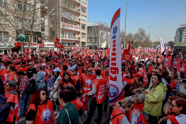 Teachers and members of education unions march during a protest against school shootings in Ankara on April 16, 2026. More than 3,500 teachers from several education unions protested in the Turkish capital Ankara on  following deadly school shootings, calling for the resignation of the education minister. (Photo by ADEM ALTAN / AFP)