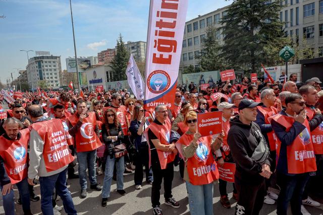 Teachers and members of education unions march during a protest against school shootings in Ankara on April 16, 2026. More than 3,500 teachers from several education unions protested in the Turkish capital Ankara on  following deadly school shootings, calling for the resignation of the education minister. (Photo by ADEM ALTAN / AFP)